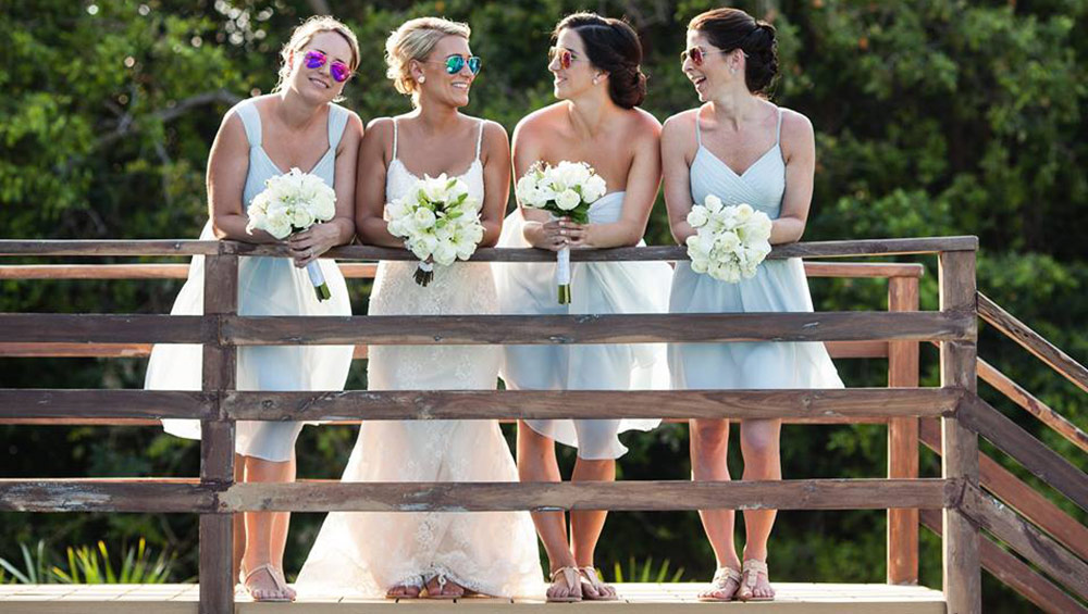 destination wedding bride and bridal party relax and laugh together