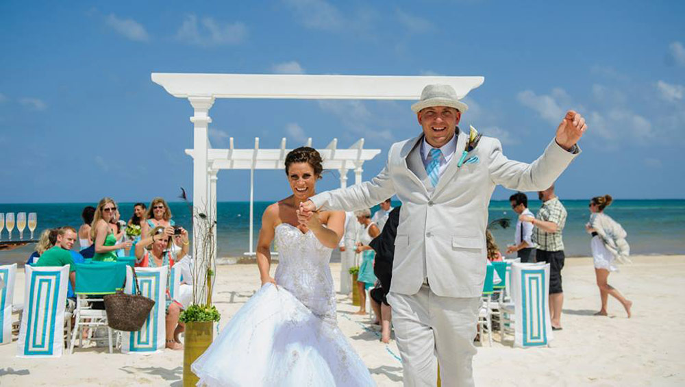 Happy couple from Calgary celebrating after beach wedding in Mexico