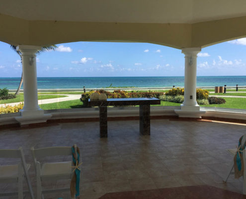 destination wedding table with beach and sea in background