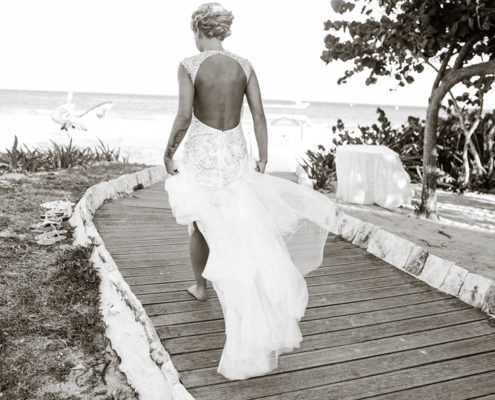 bride walking to her tropical beach wedding