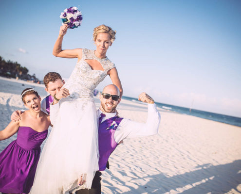 wedding party on beach celebrating the bride