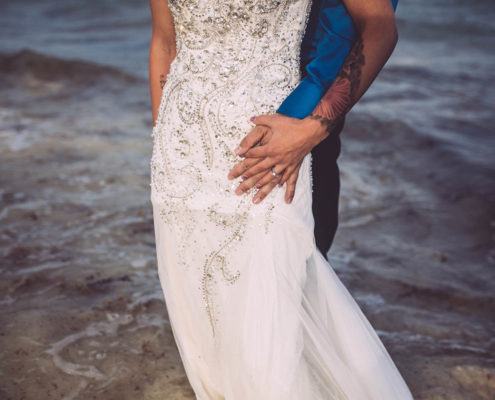 newly married wedding couple on beach in the surf.