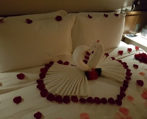 flowers making heart shape on wedding bed at destination wedding.