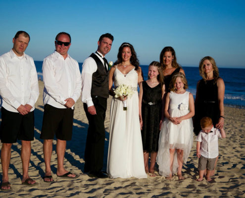 bride and groom pose with wedding party at destination wedding in Cabo
