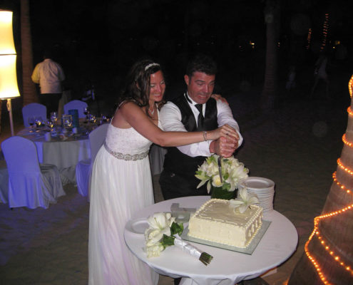 bride and groom cut cake at destination wedding