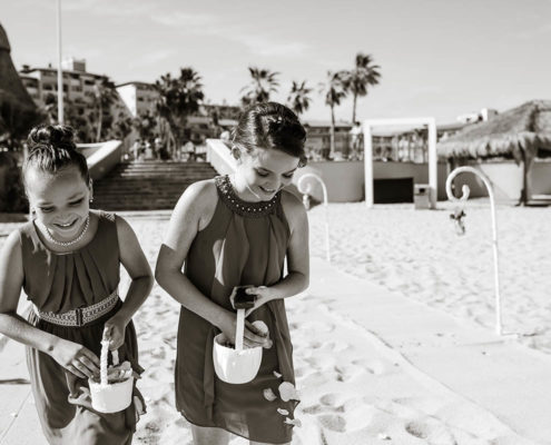 bride's maids showering petals on beach