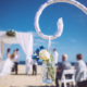 beach wedding details with couple in distance