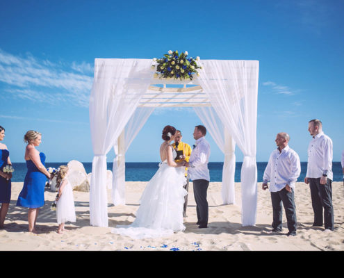 couple get married under canopy at beach wedding in Cabo