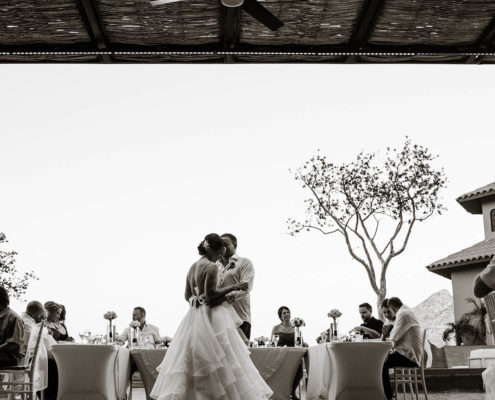 newly married couple dance in front of wedding guests